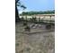 Backyard fire pit surrounded by plants with farmland views in a grassy fenced in area at 328 Glenridge Ct, Indian Trail, NC 28079