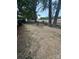 Spacious backyard featuring a rustic fire pit, perfect for outdoor entertaining under mature shade trees at 328 Glenridge Ct, Indian Trail, NC 28079