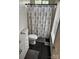 A half bath with a stylish black and white patterned shower curtain, and coordinating rug at 328 Glenridge Ct, Indian Trail, NC 28079