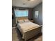 Comfortable bedroom with neutral color palette, wood floors, and natural light at 328 Glenridge Ct, Indian Trail, NC 28079