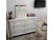 Bedroom showcasing a dresser with wall mounted tv and white shag carpet at 328 Glenridge Ct, Indian Trail, NC 28079