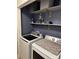 Well-equipped laundry room with modern washer and dryer, complemented by functional shelving for storage at 328 Glenridge Ct, Indian Trail, NC 28079