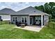 Landscaped backyard featuring a patio with outdoor seating and a well-maintained lawn at 3313 Plum Dr, Monroe, NC 28110
