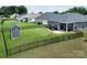 Aerial view of fenced backyards, well-maintained lawns, and patios in a residential community at 3313 Plum Dr, Monroe, NC 28110