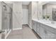 Bathroom with double sink vanity, modern fixtures, glass-enclosed shower, and neutral color palette at 3313 Plum Dr, Monroe, NC 28110