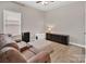 Comfortable bonus room with a sofa and storage cabinets, creating a cozy multi-purpose space at 3313 Plum Dr, Monroe, NC 28110