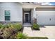Covered entryway with landscaped yard and a black front door at 3313 Plum Dr, Monroe, NC 28110