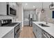 A stainless steel oven, stainless steel refrigerator, gray cabinets and quartz counters at 3313 Plum Dr, Monroe, NC 28110