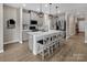 Modern kitchen with gray cabinetry, stainless appliances and an island with bar seating at 3313 Plum Dr, Monroe, NC 28110