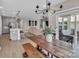 Open-concept living space with modern chandelier, stainless steel appliances, and sliding door access to outdoor space at 3313 Plum Dr, Monroe, NC 28110