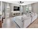 Bright living room with a large sofa, media console, and plenty of natural light at 3313 Plum Dr, Monroe, NC 28110