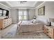 Spacious bedroom with tray ceiling, natural light, and hardwood floors, providing a comfortable retreat at 3313 Plum Dr, Monroe, NC 28110