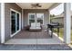 Covered patio area with outdoor seating, ceiling fan, and a grill, perfect for entertaining at 3313 Plum Dr, Monroe, NC 28110