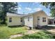 Side and front view of a simple, light yellow single-story home featuring a brick walkway at 333 Friendship Dr, Rock Hill, SC 29730