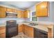 Functional kitchen with wood cabinets, black appliances and a double sink at 333 Friendship Dr, Rock Hill, SC 29730