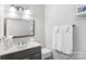 This bathroom features a single sink with wood cabinets and a framed mirror at 3705 Chesapeake Pl, Waxhaw, NC 28173