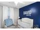 This Bedroom features a crib and an accent wall with personal touches at 3705 Chesapeake Pl, Waxhaw, NC 28173
