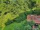 Elevated view of a deck overlooking a verdant backyard and mature trees, ideal for entertaining and privacy at 3705 Chesapeake Pl, Waxhaw, NC 28173