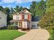 Charming two-story home with a welcoming front porch and a well-manicured lawn in a desirable neighborhood at 3705 Chesapeake Pl, Waxhaw, NC 28173
