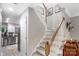 Well-lit hallway showcasing staircase with wood railing and modern decor leading to other parts of the home at 3705 Chesapeake Pl, Waxhaw, NC 28173