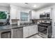 Bright kitchen featuring stainless steel appliances, white cabinetry, and efficient layout for easy cooking at 3705 Chesapeake Pl, Waxhaw, NC 28173