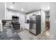Spacious kitchen featuring stainless steel appliances, granite countertops, and ample cabinet space at 3705 Chesapeake Pl, Waxhaw, NC 28173