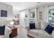 Cozy living room with modern decor, featuring neutral tones, wood floors and bright natural light at 3705 Chesapeake Pl, Waxhaw, NC 28173