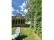 Back of the house with screened in porch, next to some tall bushes and a chair in the foreground at 408 E Blume St, Landis, NC 28088