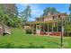 The outdoor space features a screened-in porch, steps, manicured lawn, and mature landscaping at 408 E Blume St, Landis, NC 28088