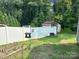 Fenced backyard offering privacy and security, complete with a shed and well-maintained lawn, great for outdoor activities at 408 E Blume St, Landis, NC 28088
