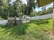 View of the backyard featuring a pool with small pool house and wood deck along with a white fence and grassy area at 408 E Blume St, Landis, NC 28088