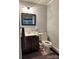 Simple bathroom featuring a toilet, a single sink vanity with a mirror, and patterned floor tiles at 408 E Blume St, Landis, NC 28088
