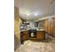 Kitchen with an island, tile floors, and wooden cabinets offering lots of storage, creating a functional cooking space at 408 E Blume St, Landis, NC 28088