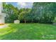 Large backyard features a storage shed and plenty of green space, ideal for relaxation at 4230 Chatterleigh Dr, Monroe, NC 28110