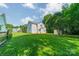 Expansive backyard with lush green lawn and mature trees, perfect for outdoor activities at 4230 Chatterleigh Dr, Monroe, NC 28110
