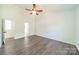 Spacious bedroom with vaulted ceiling and hardwood floors, featuring a ceiling fan and open doorways at 4230 Chatterleigh Dr, Monroe, NC 28110
