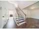 Bright foyer with hardwood floors, stairway, and views into adjacent rooms at 4230 Chatterleigh Dr, Monroe, NC 28110