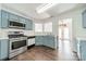 Well-equipped kitchen with stainless steel appliances and blue cabinets at 4230 Chatterleigh Dr, Monroe, NC 28110