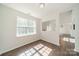 Bright, open living room featuring hardwood floors and natural light from a large window at 4230 Chatterleigh Dr, Monroe, NC 28110