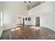 Bright living room showcasing an open floor plan, with hardwood floors and natural light from many windows at 4230 Chatterleigh Dr, Monroe, NC 28110