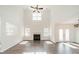 Spacious living room with high ceilings, fireplace, hardwood floors, and abundant natural light at 4230 Chatterleigh Dr, Monroe, NC 28110