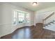 Sunlit living room features a large bay window, hardwood flooring, and modern trim at 4230 Chatterleigh Dr, Monroe, NC 28110