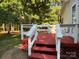 Exterior view of red deck with white railings at 44112 Harper Hearne Rd, New London, NC 28127