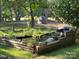 Backyard featuring a wooden bordered pond, a boulder, and greenery, creating a peaceful backyard retreat at 44112 Harper Hearne Rd, New London, NC 28127