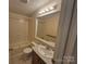 Bathroom featuring bathtub, toilet, vanity, mirror and lights at 44112 Harper Hearne Rd, New London, NC 28127