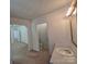 Bathroom featuring toilet, sink, and entrance to other room at 44112 Harper Hearne Rd, New London, NC 28127