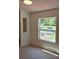 Bright bedroom with a large window showcasing the natural landscaping and sunlight at 44112 Harper Hearne Rd, New London, NC 28127