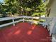 Close up view of an open backyard deck with white railing at 44112 Harper Hearne Rd, New London, NC 28127