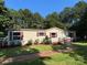 Charming single-story home featuring a red roof, ramp access, and a well-manicured lawn at 44112 Harper Hearne Rd, New London, NC 28127