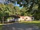 Charming single-story home with a carport, a red roof and red trim, set on a landscaped lot with mature trees at 44112 Harper Hearne Rd, New London, NC 28127